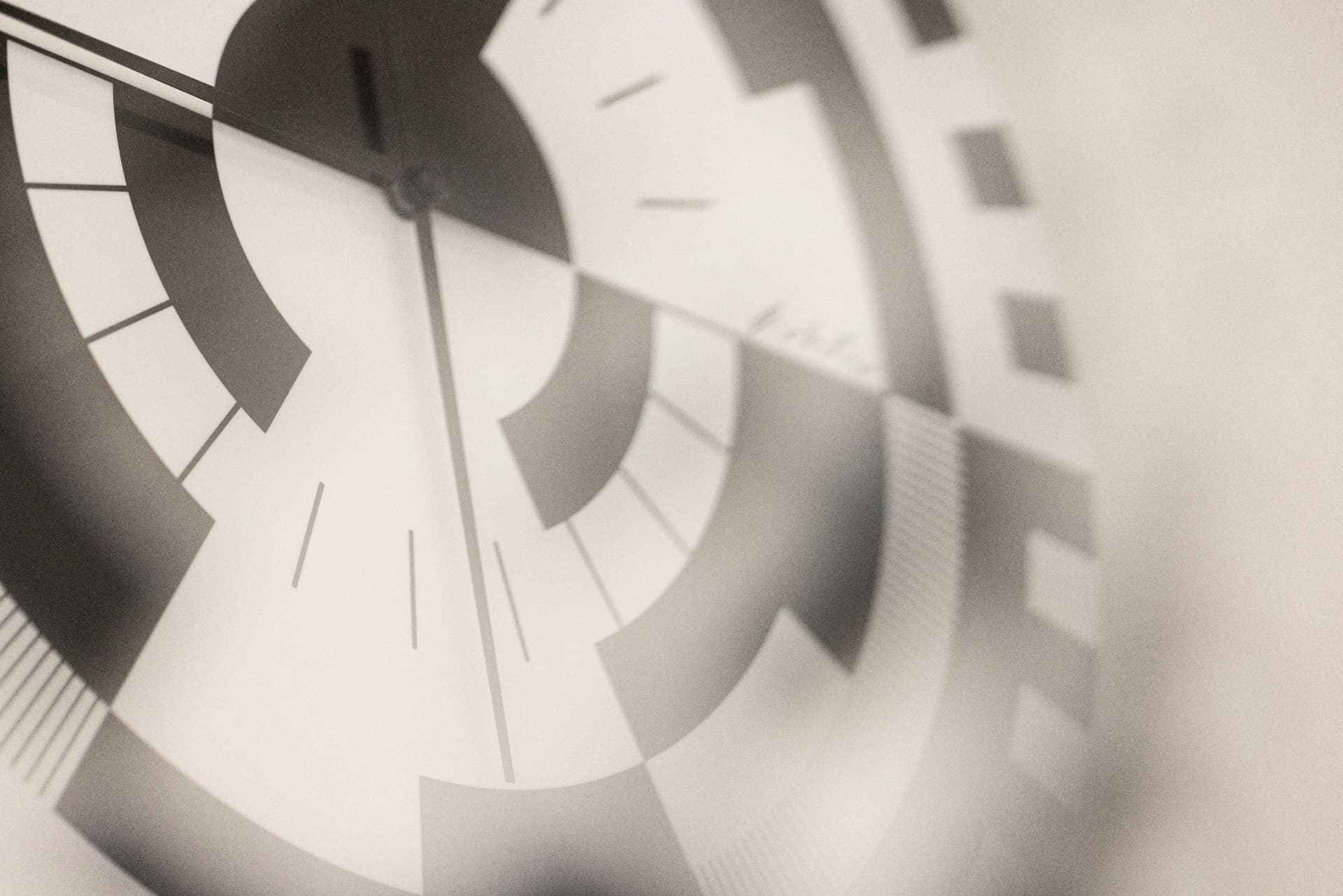Graphic black-and-white wall clock with concentric circle segments